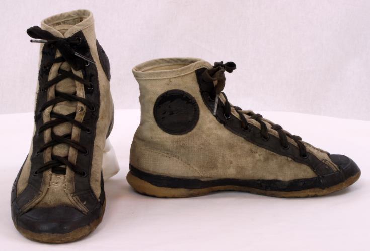 Front and side view of ankle high-top canvas shoes from the 1930s