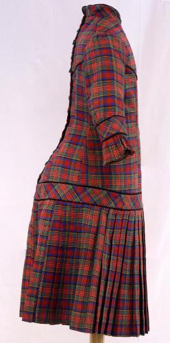 Side view of a plaid childs dress from the 1880s