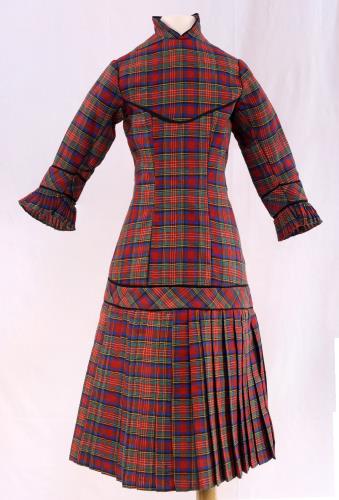 Front view of a plaid childs dress from the 1880s