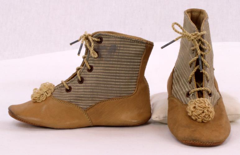 Front and side view of striped baby shoes from the 1900s