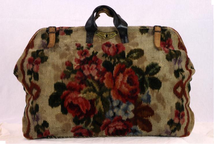 Front view of a carpet bag with rose designs from the 1860s