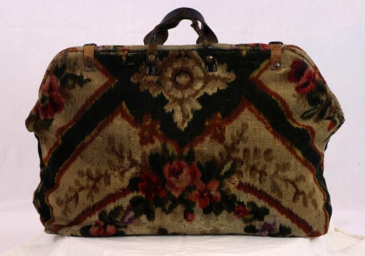 Back view of a carpet bag with rose designs from the 1860s