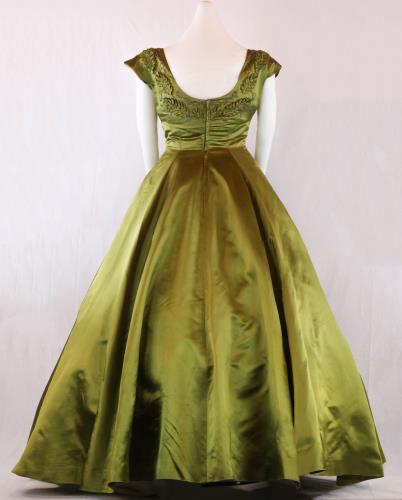 Back view (lighter) of a olive green, floor length, acetate satin evening gown from the 1950s