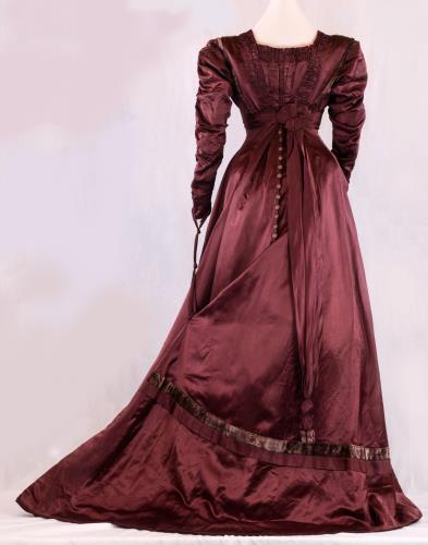 Back view of a long maroon satin empire gown from the 1910s