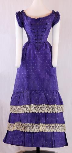 Front view of a three piece violet, floral printed silk ensemble from the 1860s