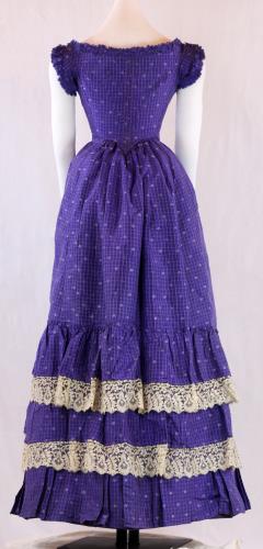 Back view of a three piece violet, floral printed silk ensemble from the 1860s