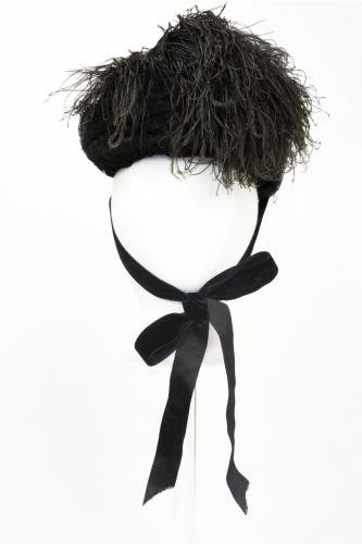 Front view of a black feather hat from the 1890s
