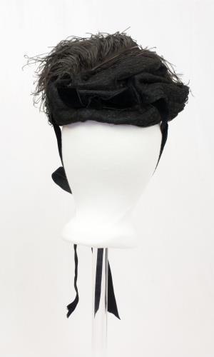 Back view of a black feather hat from the 1890s