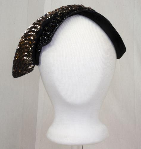 Front view of a black velvet hat with pink sequens, circa 1950.