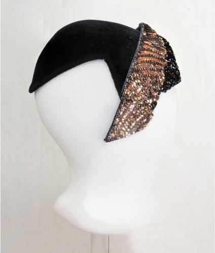 Right side view of a black velvet hat with pink sequens, circa 1950.