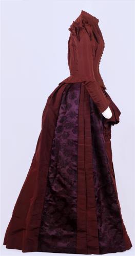 Side view of a hannifin burgandy dress, circa 1880.
