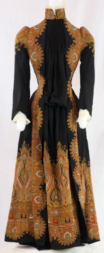 Front view of a black and paisley dress from the 1890s