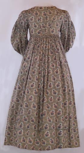 Back view of a long sleeved flower print pioneer ladies dress from the 1830s