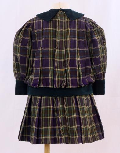 Back view of a purple and green plaid dress from the 1900s