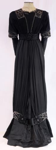 Back view of a two piece black silk gown from the 1910s