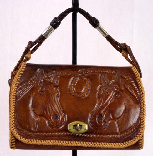 Front view (closed) of a heavy brown leather purse from the 1950s
