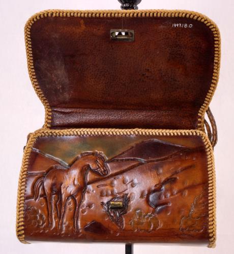 Front view (open) of a heavy brown leather purse from the 1950s
